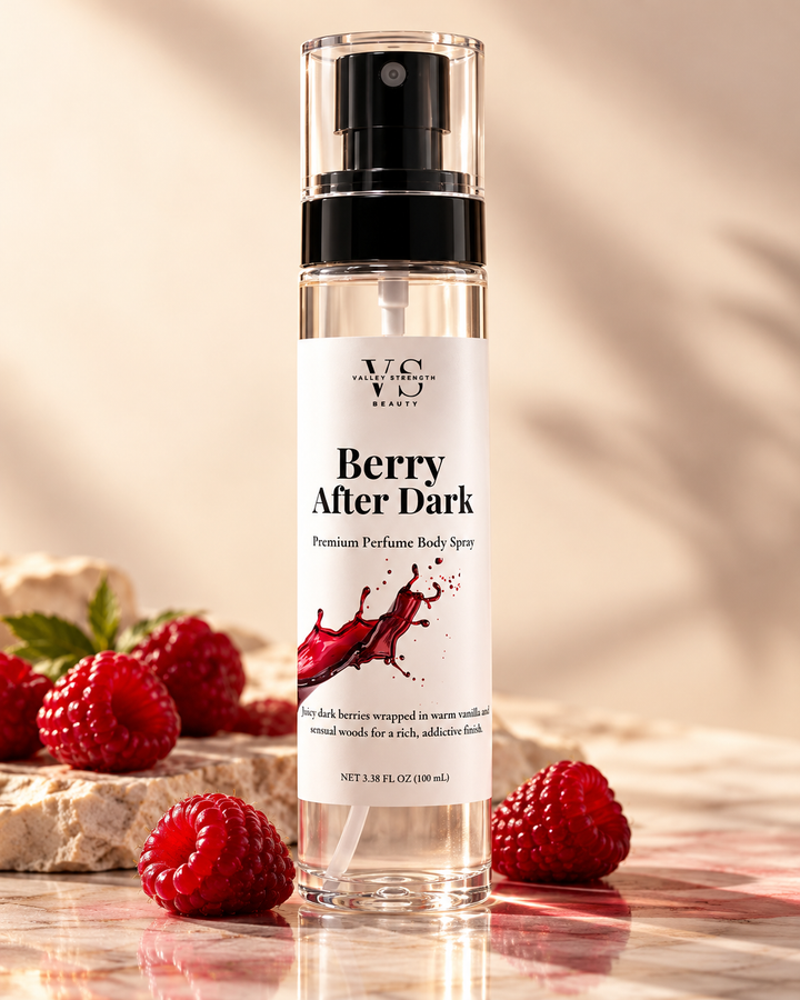 Berry After Dark perfume body spray with strawberries on a sunlit stone surface